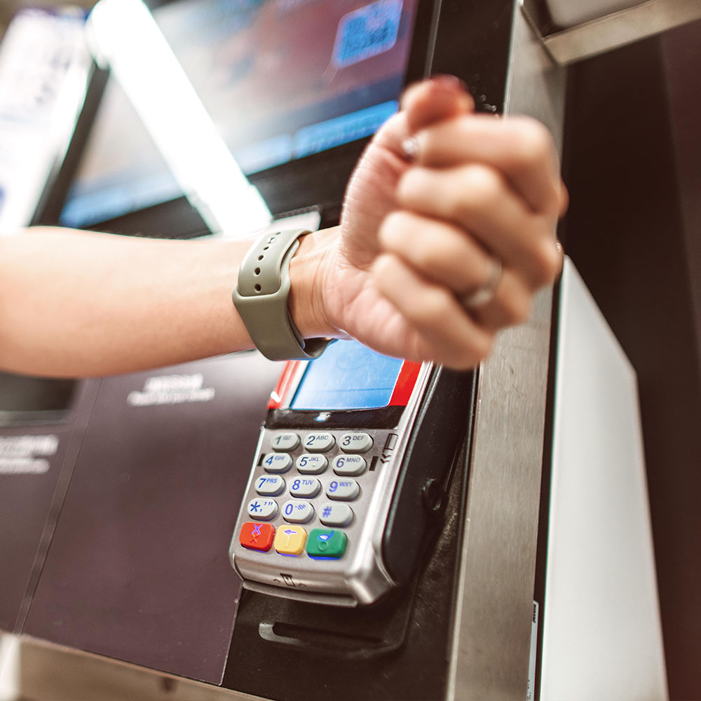 Individual using watch to make a payment