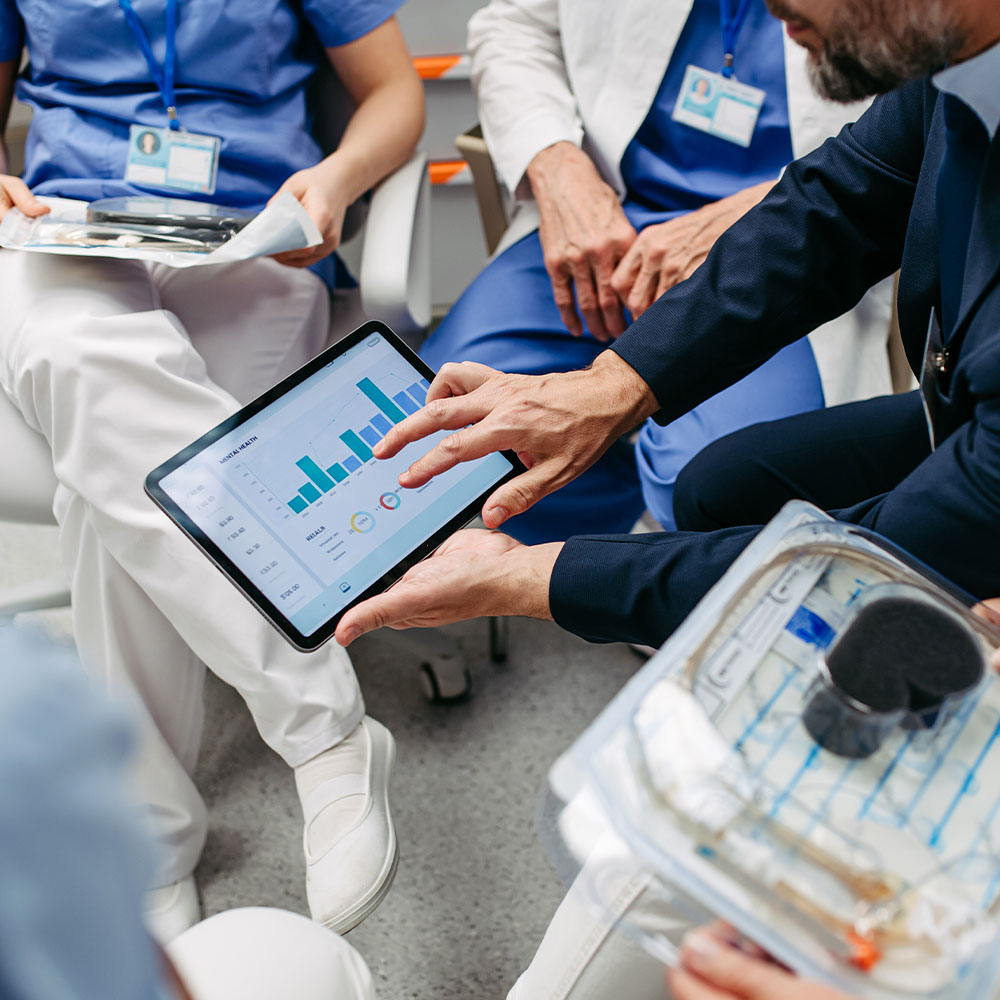 Group of medical professionals looking at tablet