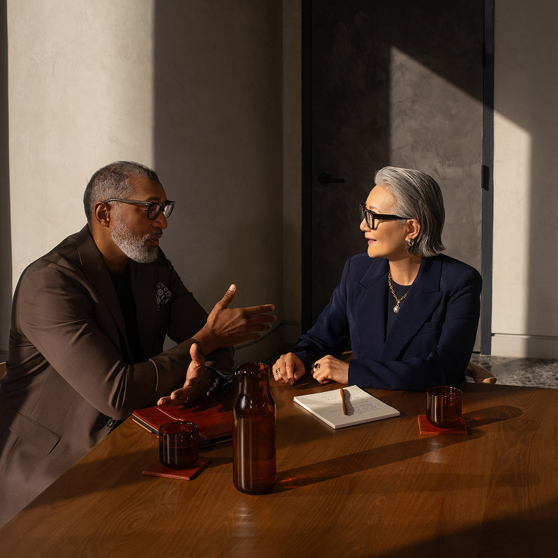 2 people in office talking