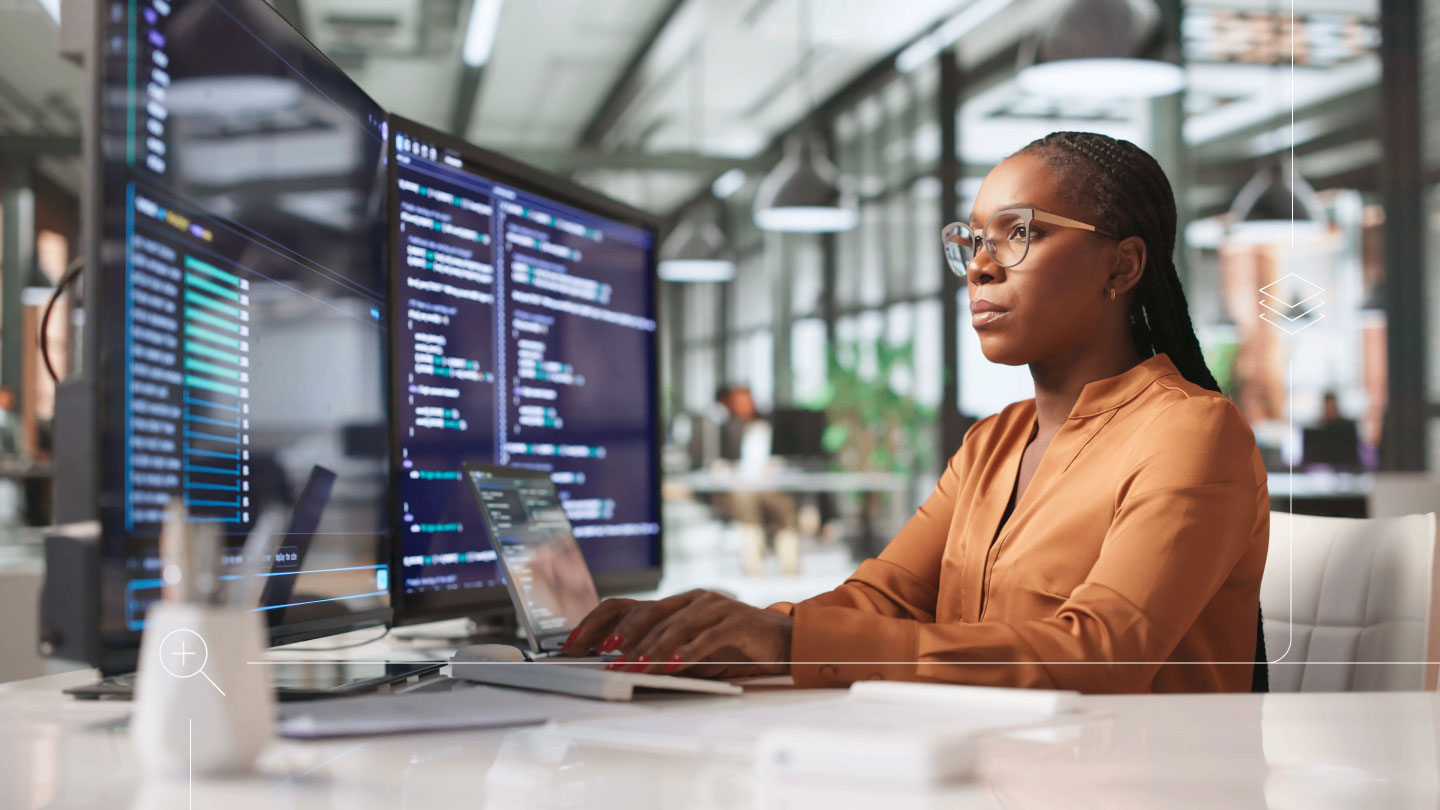 woman using computer and monitors