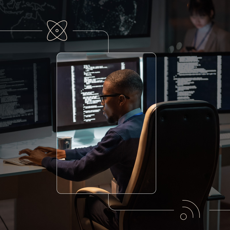 Man using computer with monitors