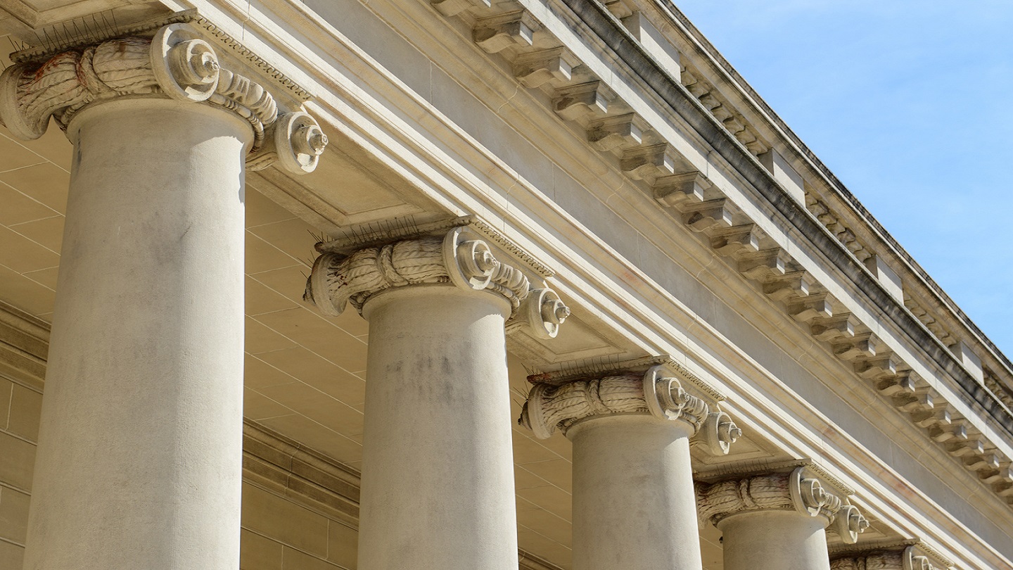 Pillars of Education with a Blue Sky Background