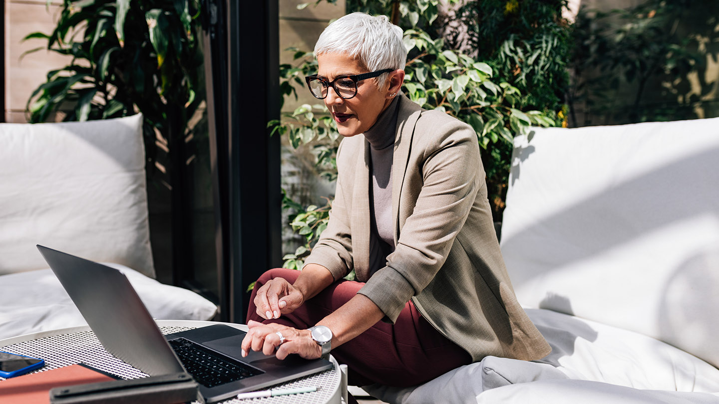 Elegant businesswoman working on her laptop pc in her company