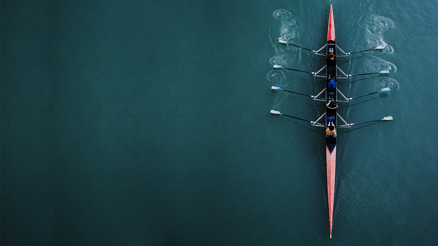 Kayak from above with 4 rowing people. Blue and aqua water background. Sport and moving concept. Red kayak and 8 paddles.