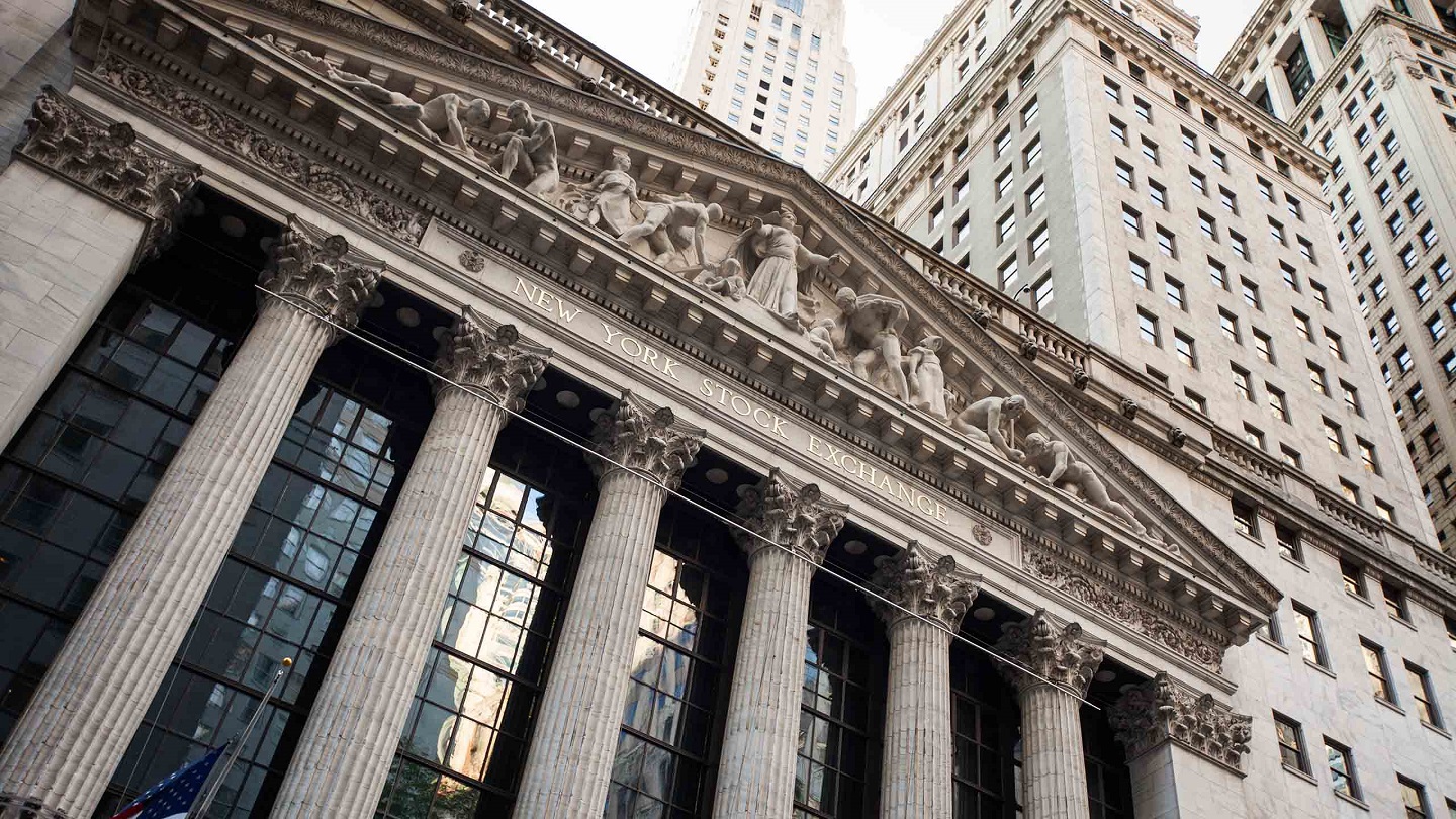 New York City, USA - May 6, 2015: Daylight upward horiztonal image of main facade of the famous New York Stock Exchange Building, the largest stock exchange in the world. This historic landmark, located at 11 Wall Street, has been in continuous operation since it was built in 1903. Tilt-shift lens used for abstract blur effect.