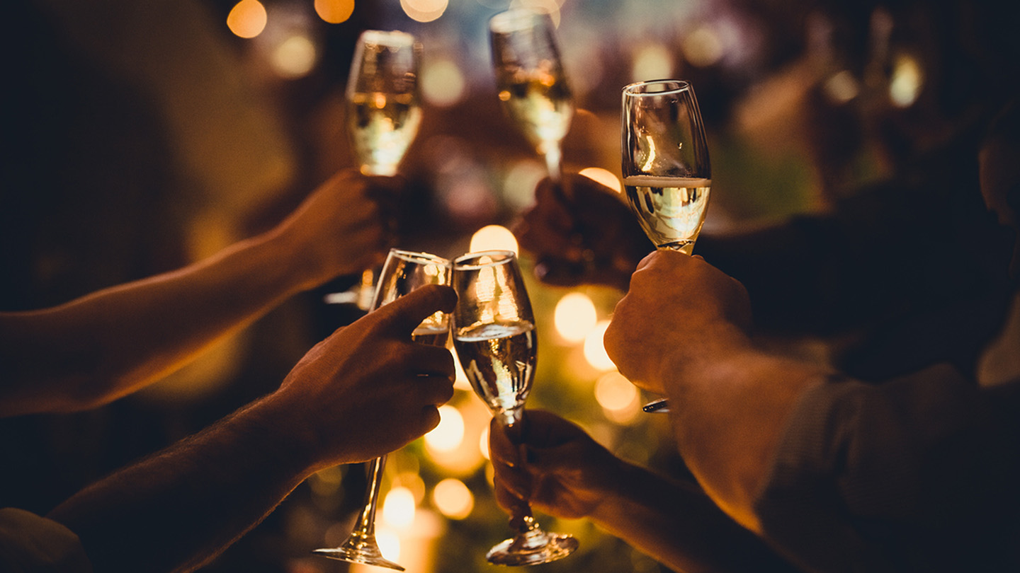 Numerous hands holding champagne flutes with champagne celebratory toast silhouettes