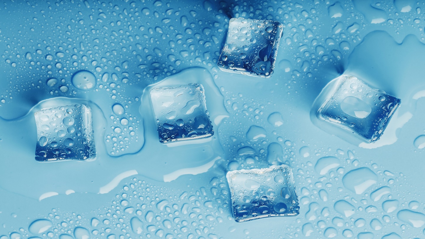 Ice cubes with drops of melt water water on a blue background, top view. Freshness in the sultry heat. Cooling drinks