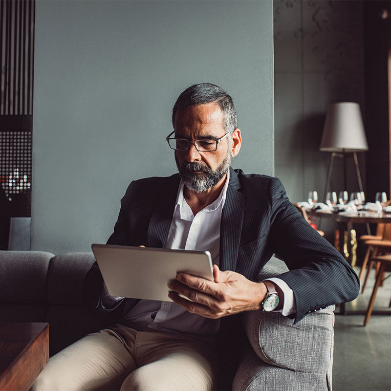 Businessman Reading on Tablet