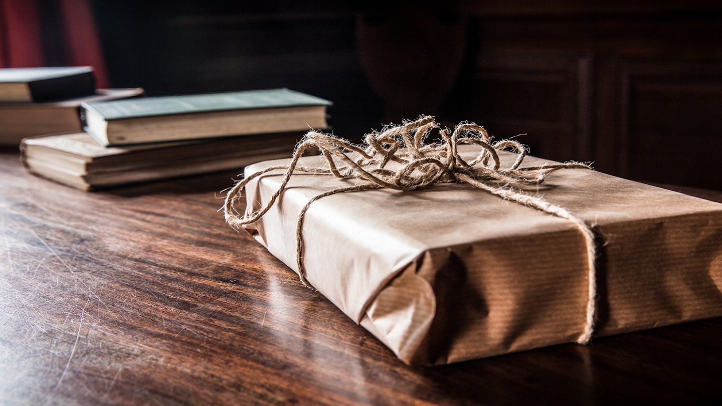 Victorian yuletide wrapped Christmas presents in brown paper and tied with string.